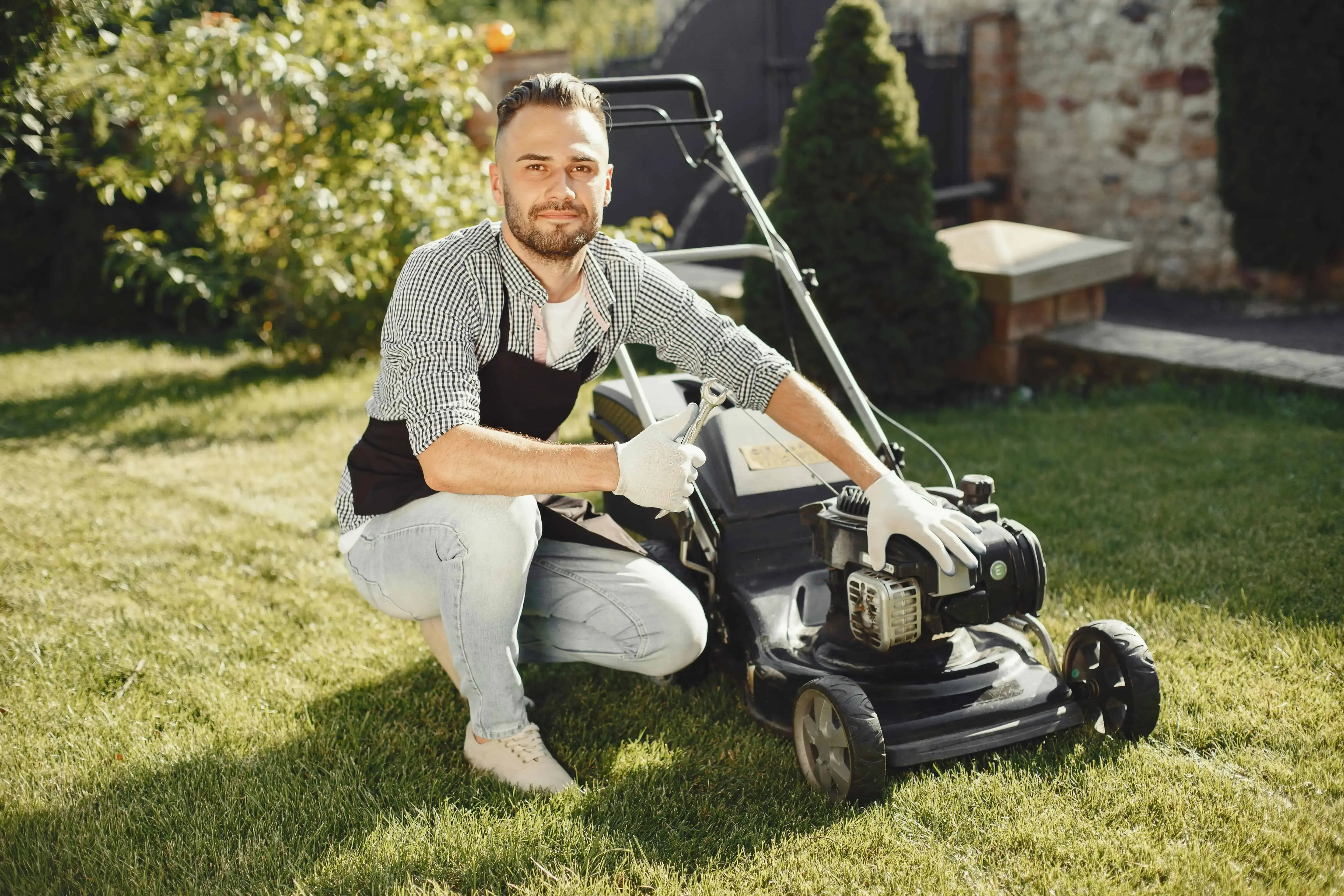 Lawn care worker setting up mower before scheduled service
